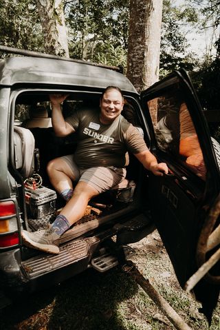 A man riding in the back of a car