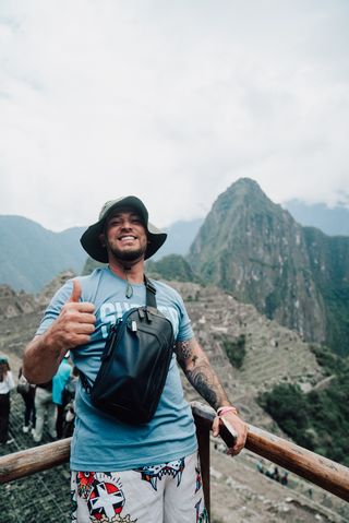 A man smiling at Machu Picchu