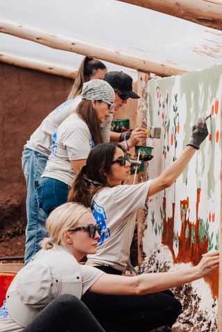 A group of reps painting a wall