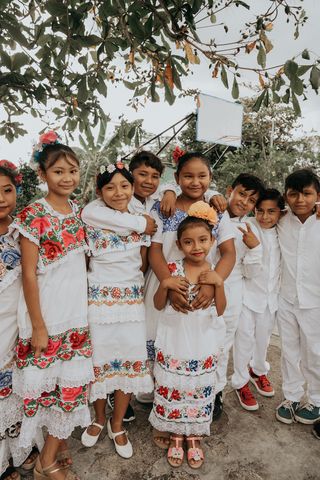A group of children in white attire
