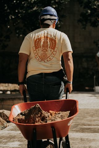 A man pulling a wheelbarrow