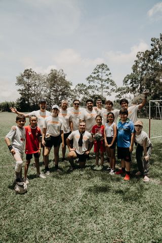A group posing at a soccer field