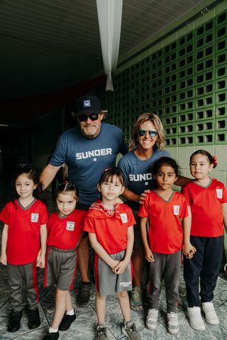 Man and woman behind a group of kids